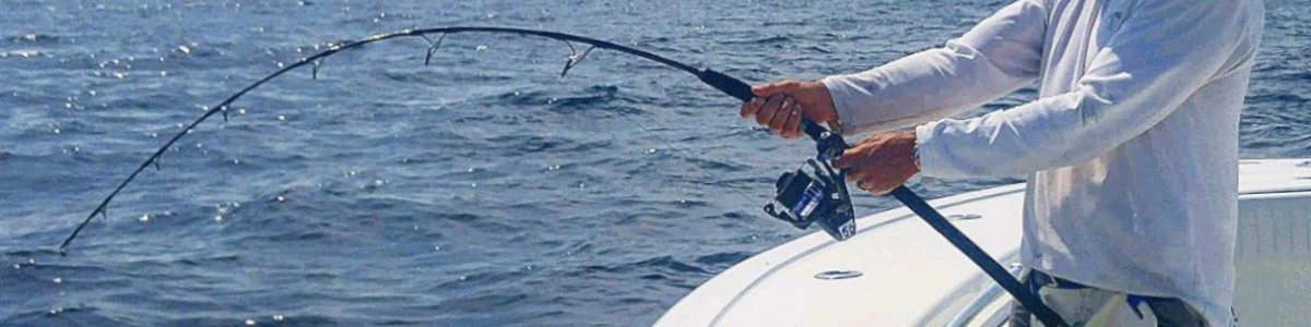 An angler fishing off a boat with an OTI fishing rod